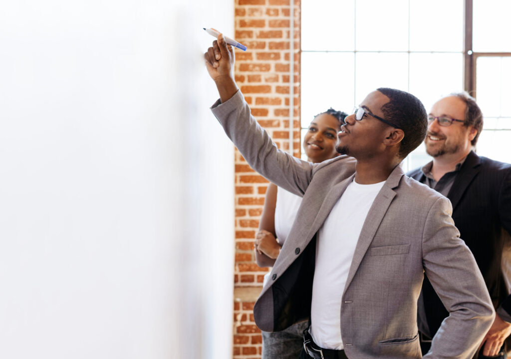 Businessman writing on a white board