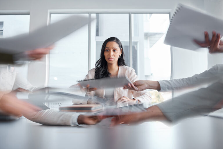 Business woman, anxiety and stress in a meeting or busy office with documents or paperwork. Professional female manager at table with team hands for stress, depression or burnout for deadline crisis Business woman, anxiety and stress in a meeting or busy office with documents or paperwork. Professional female manager at table with team hands for stress, depression or burnout for deadline crisis.