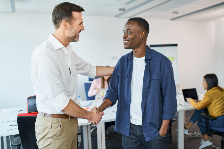 Business onboarding concept. Manager welcomes new employee in startup business office. Business onboarding concept. Manager welcomes new employee in startup business office.