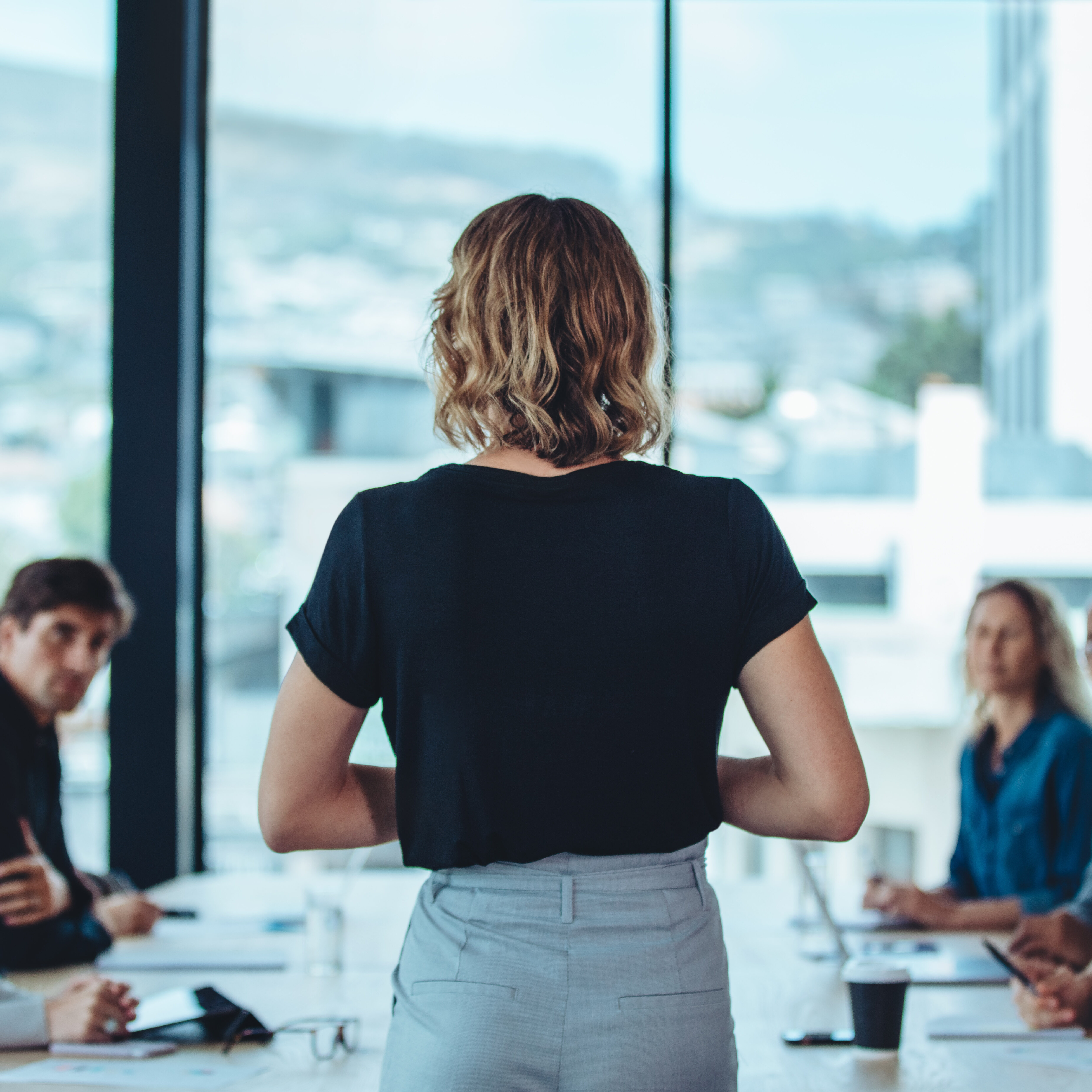 Female business leader conducting a meeting Woman addressing a meeting in office boardroom. Businesswoman having a meeting with her office staff.